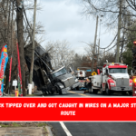 A dump truck tipped over and got caught in wires on a major Staten Island route