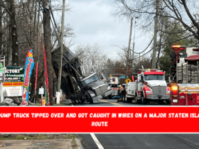 A dump truck tipped over and got caught in wires on a major Staten Island route